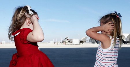 Children cover their ears as the F-35s landed.